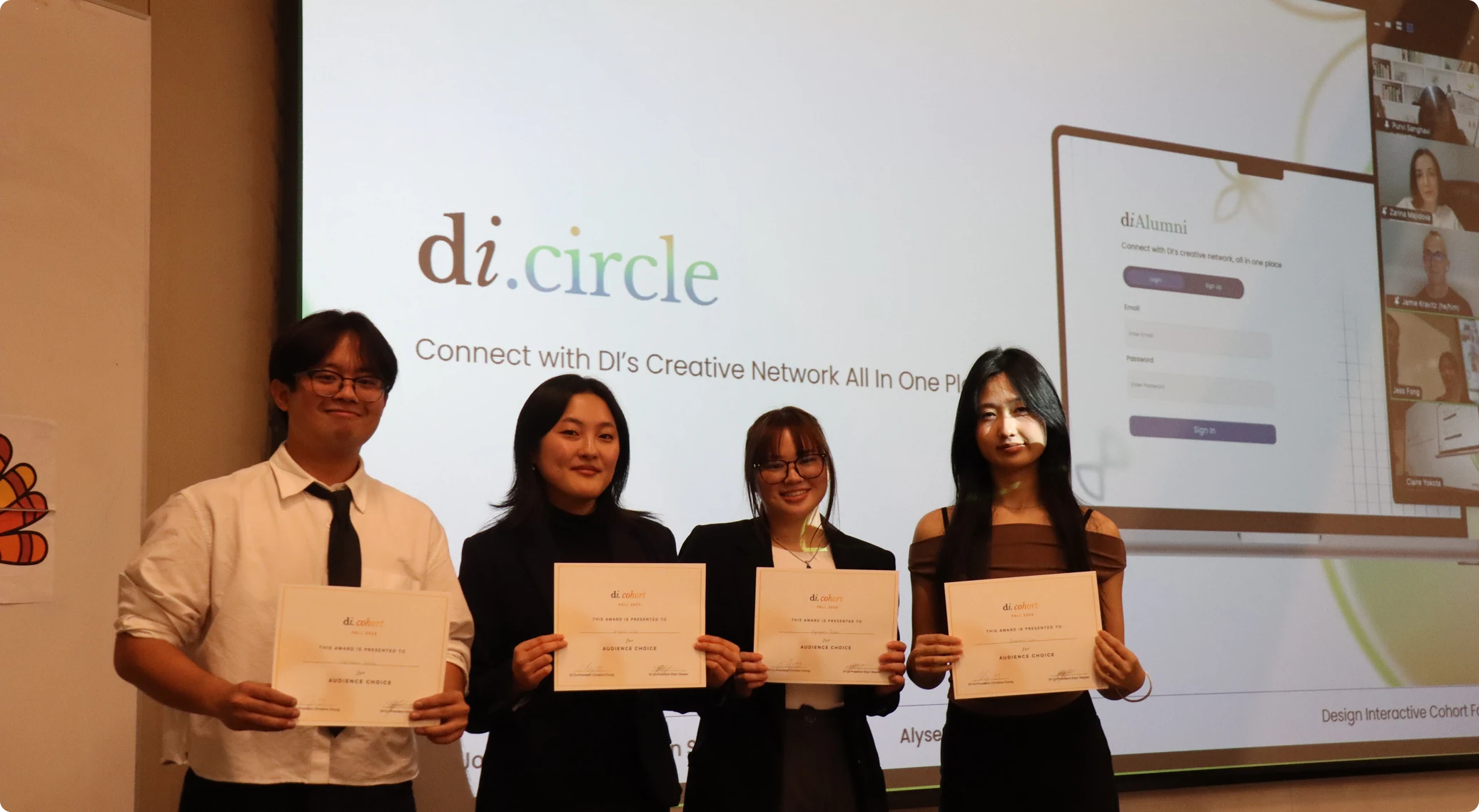 The four-person di.circle team holding their Audience Choice certificates in front of a screen showing the di.circle presentation